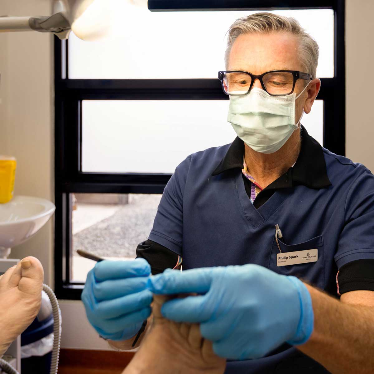 Podiatrist treating a patient for foot conditions at Total Care Podiatry in Geelong