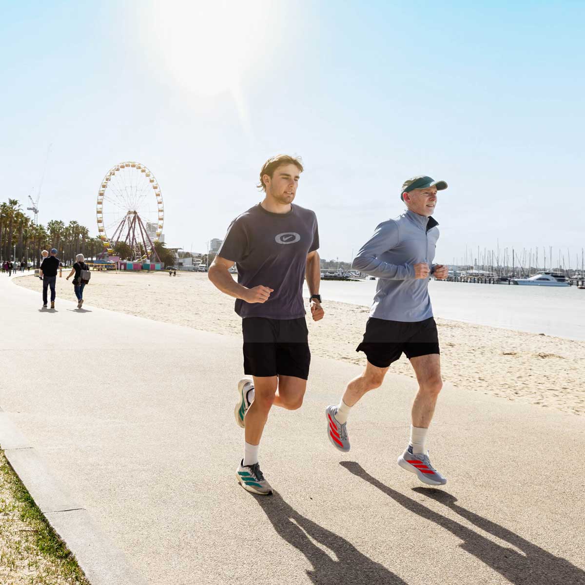 Two men running along Eastern Beach Geelong after consultation with Total Care Podiatry podiatrists